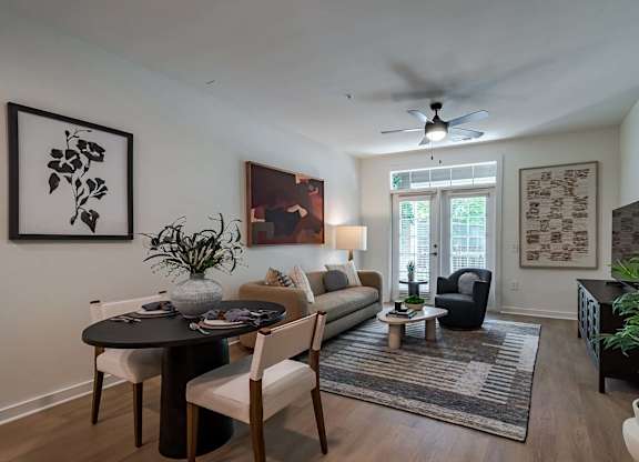 A living room with a dining table and chairs.