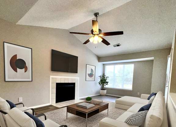 Charlotte, NC, Apartments with In-Unit Washer and Dryer - Coffey Creek - A Living Room With A Vaulted Ceiling With Ceiling Fan, White Sofa, And Chairs.