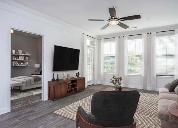 A living room with a black chair in the center.
