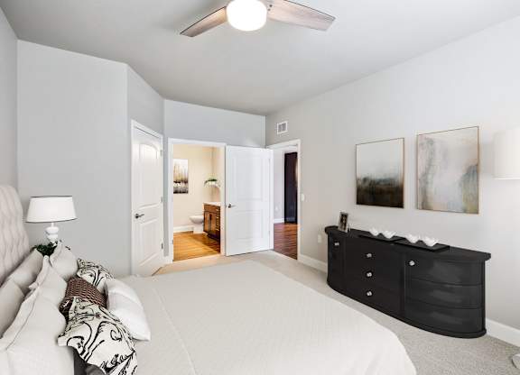 A bedroom with a large bed and a dresser.
