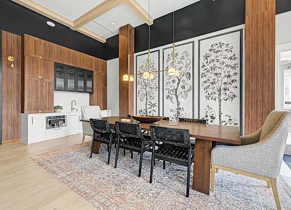 A dining room with a table set for four.
