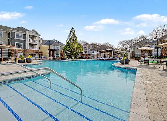 A swimming pool surrounded by a residential area.