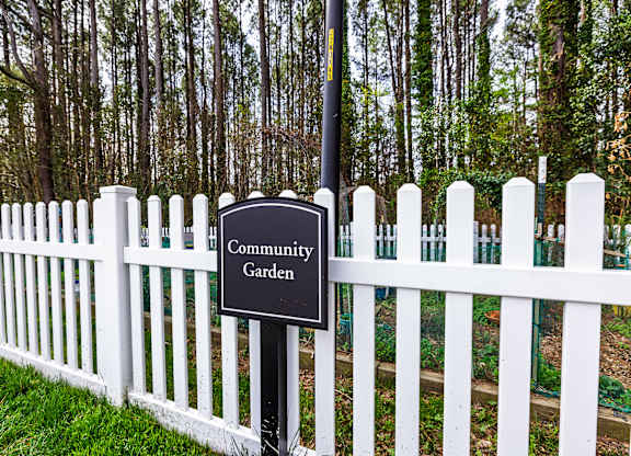 A sign that says Community Garden is mounted on a post.