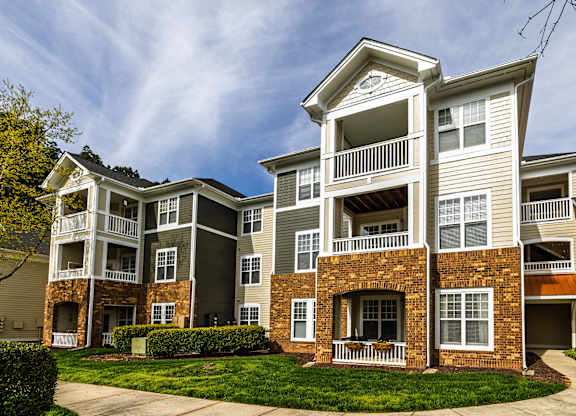 A large apartment building with multiple balconies and windows.