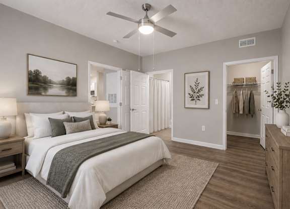 A bedroom with a large bed, a dresser, and a mirror.