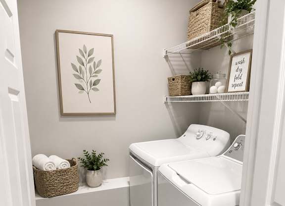 A small laundry room with a washer and dryer.