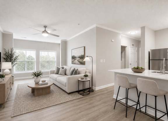 A modern living room with a white sofa, a coffee table, and a bar area with stools.
