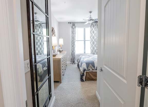 A bedroom with two beds and a ceiling fan.