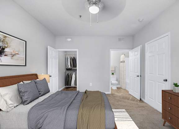 A bedroom with a bed, dresser, and a painting on the wall.