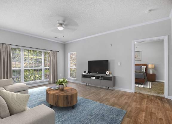 A living room with a television, a couch, and a coffee table.