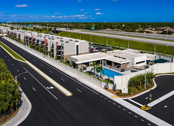 A road with a yellow line in the middle and a building on the right side.