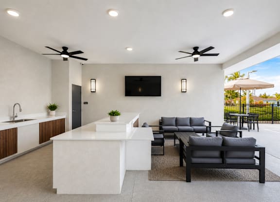 A modern outdoor living space with a kitchen area.