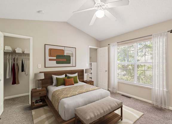 Loganville, GA, Townhomes Near Bishop Park - Alexander Crossing - Cozy Bedroom With Wood Bed Frame, Ceiling Fan, Large Window With Sheer Curtains, and Oversized Closet Storage.