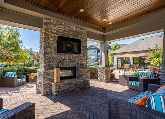 the preserve at ballantyne commons covered patio with fireplace and seating