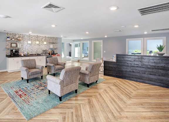 A living room with a stone backsplash and wooden flooring.