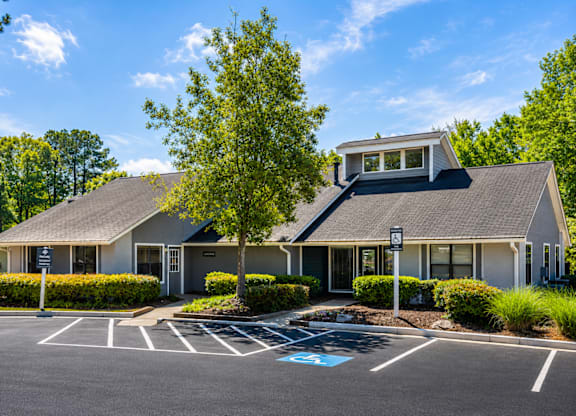 A building with a parking lot in front of it.