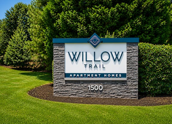 A sign for Willow Trail Apartment Homes with 1500 homes.