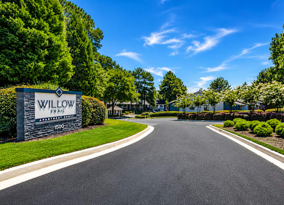 A road leading to a sign that says Willow.