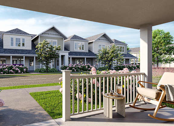 a patio with chairs and a table on a porch in front of houses