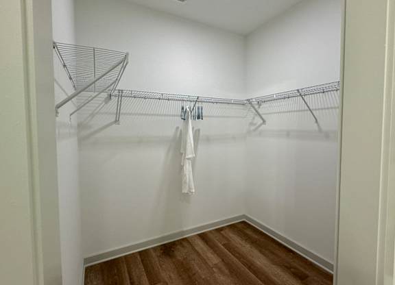 A white closet with a white towel hanging on a rod at Allier Foley, Foley, AL 36535