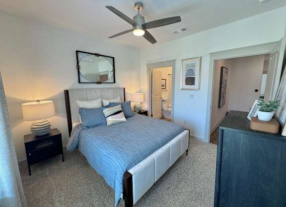 A bedroom with a bed, nightstand, and a ceiling fan at Allier Foley, Alabama