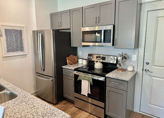 A kitchen with a black refrigerator, stove, and microwave at Allier Foley, Foley, Alabama