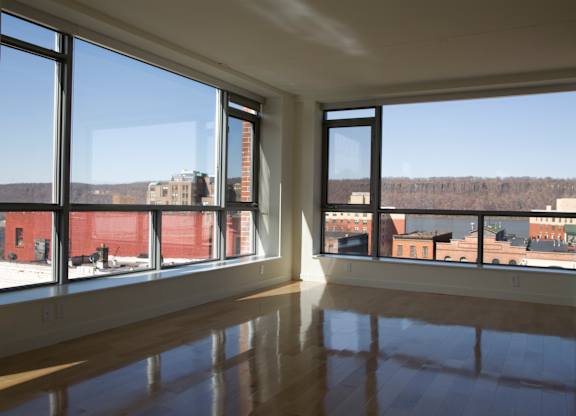 A large empty room with a view of the city.