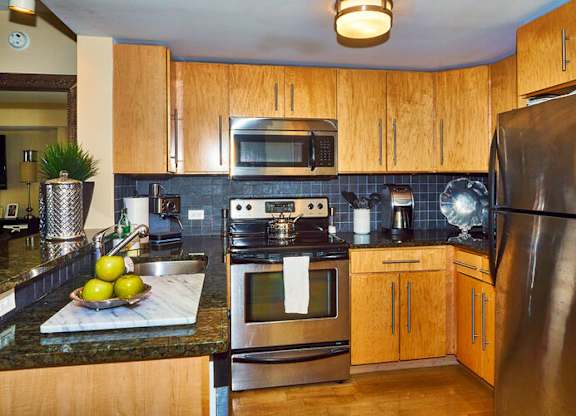 66 Main - Kitchen w/ Granite Counter and Backsplash