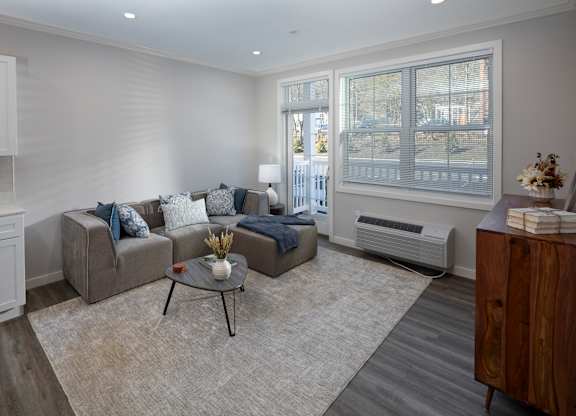 A living room with a grey couch and a coffee table.