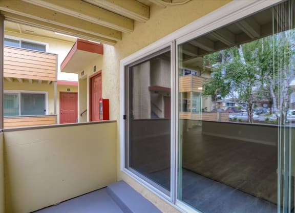 a patio with a large glass door and a balcony