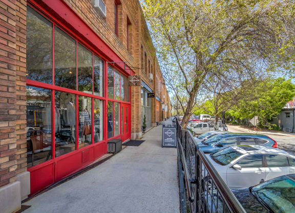a brick building with a red exterior and a sidewalk in front of it