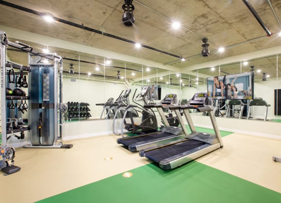 a spacious gym with treadmills and other exercise equipment