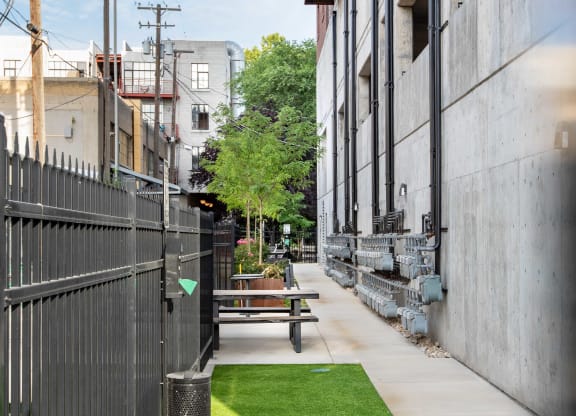 a small patch of grass in front of a building