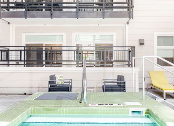 a view of the pool and deck from the hot tub