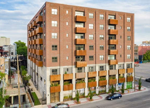 a red brick apartment building with wooden balconies