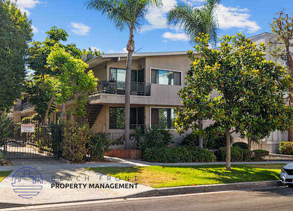 A house with a sign that says Beach Front Property Management.