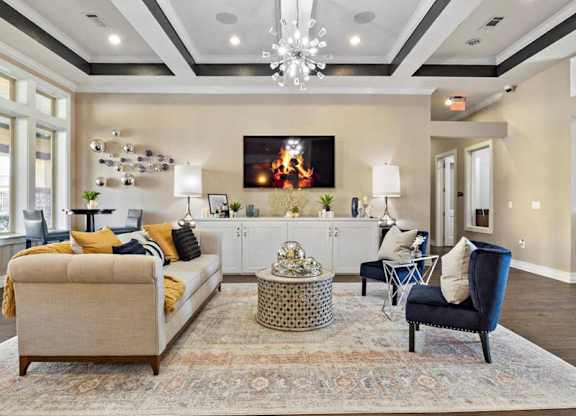 A living room with a large couch, a chair, and a coffee table.