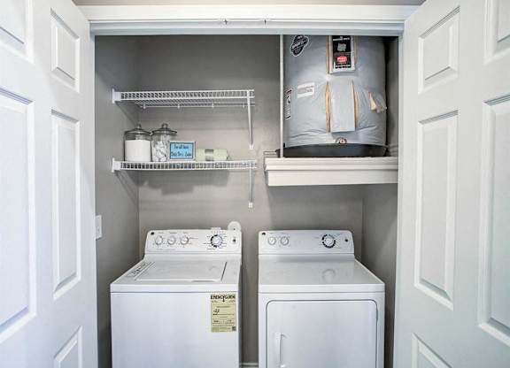 A small laundry room with a washer and dryer.