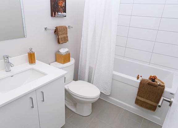 a white bathroom with a sink toilet and tub