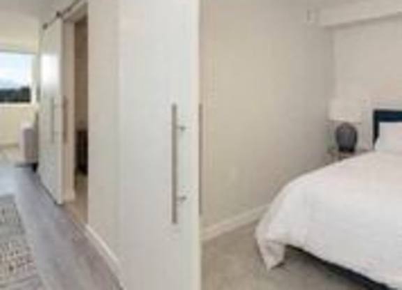 Cozy Bedroom with Sliding Barn Style Doors at Arabella Apartment Homes, Shoreline, WA