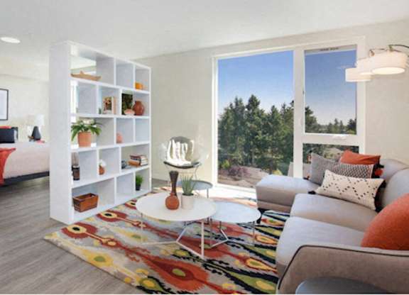 Studio Apartment with Living Room and Bedroom View with White Bookshelf separating and floor-to-ceiling windows at Arabella Apartment Homes, Shoreline