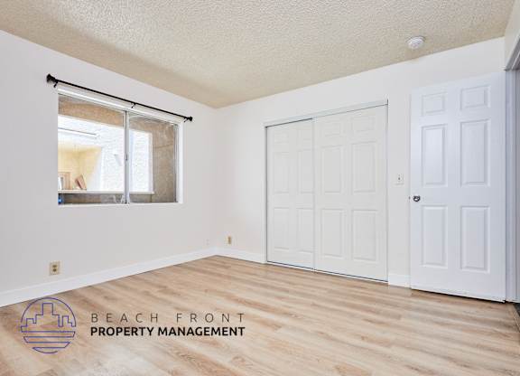 A room with a sliding glass door and a white door.