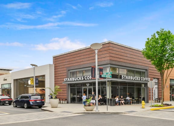 a starbucks coffee shop on the corner of a city street