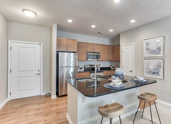 a kitchen with an island and two stools