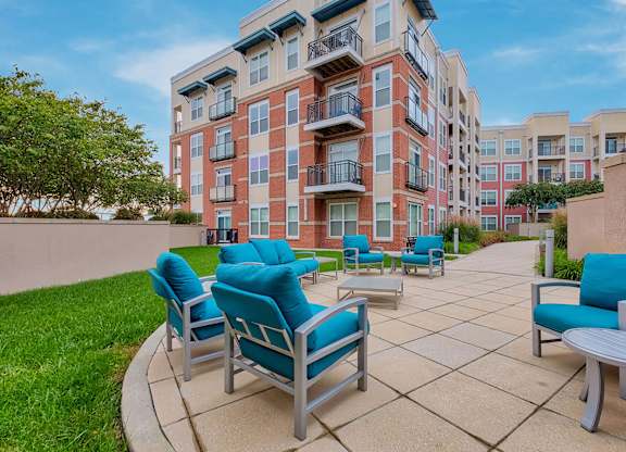 a patio with chairs and tables at the bradley braddock road station apartments