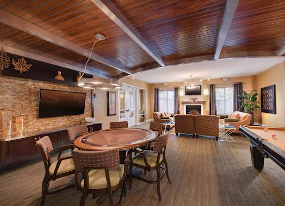 a resident clubhouse with a pool table and flat screen tv