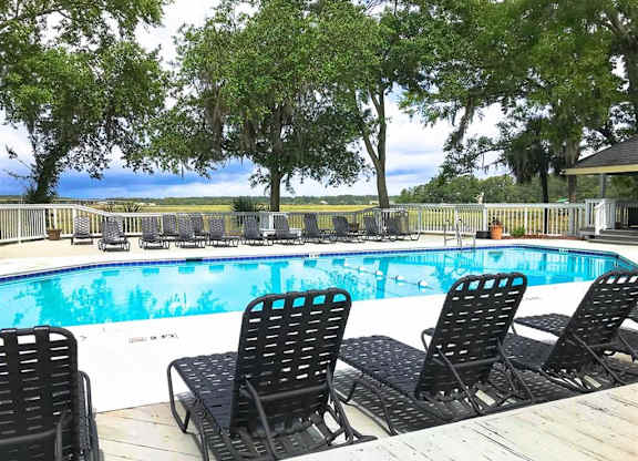Swimming pool with black chairs at West Wind Landing, Savannah, Georgia.