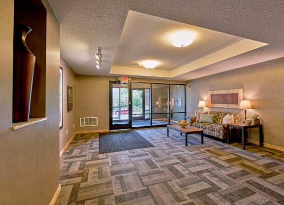 A lobby with a couch and coffee table.