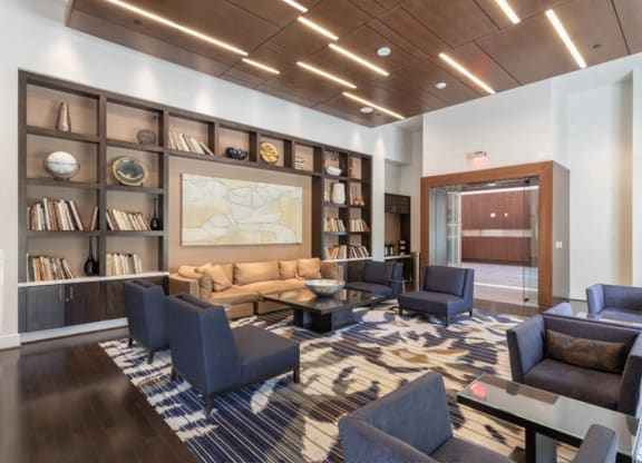 a lobby with couches and chairs and a large map on the wall at The Millennium, Arlington, 22202