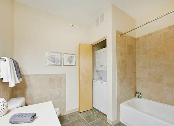 A bathroom with a white tub and toilet.
